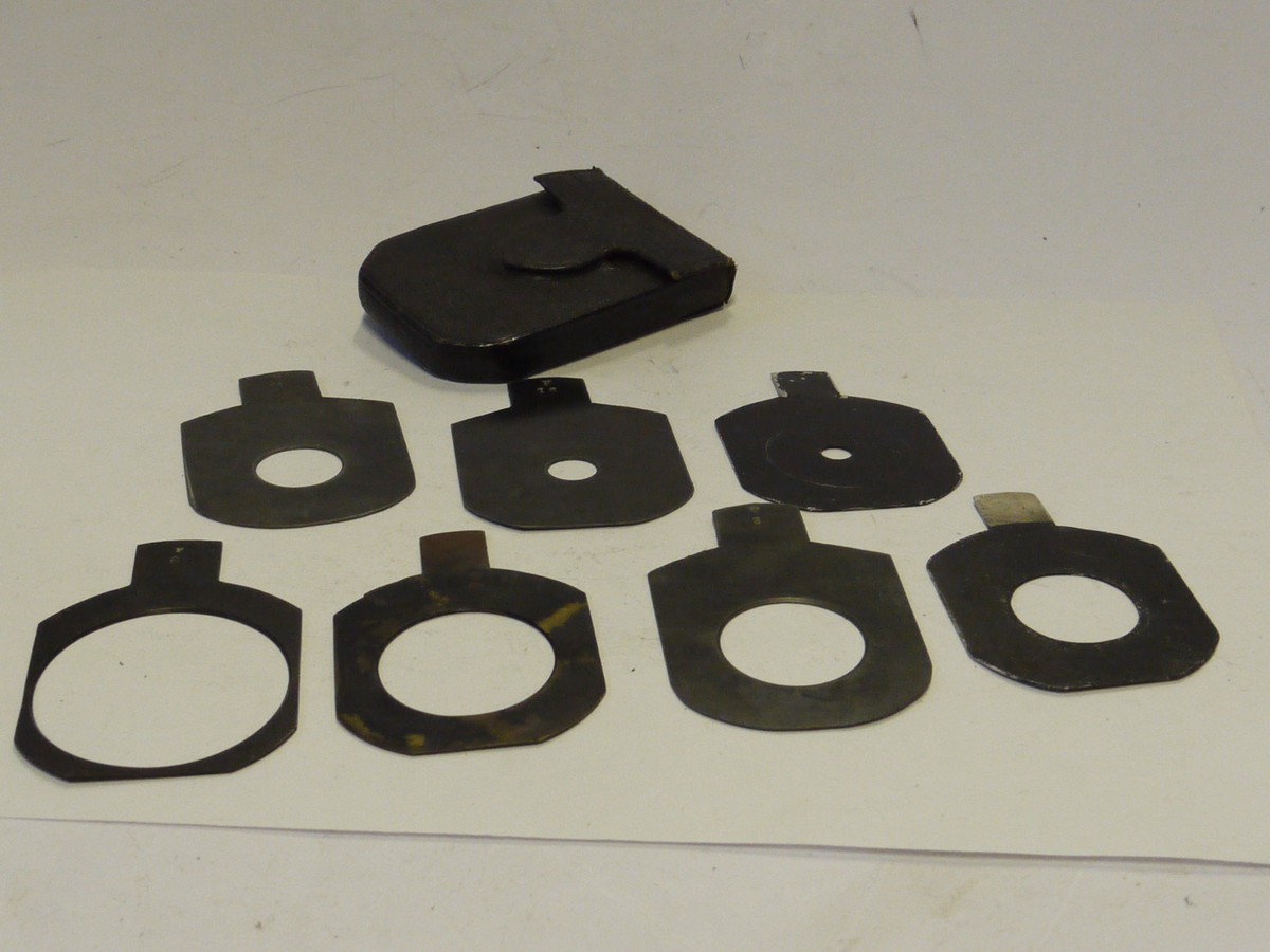 mwclassiccameras-20241129-88 Unamed Waterhouse stops Two sets of Metal Stops. Four stops marked f6, f8, f11 & f16 (60x47mm) + Unmaerked set of three different stops (54x48mm). All with end handle grips in one Green leather case