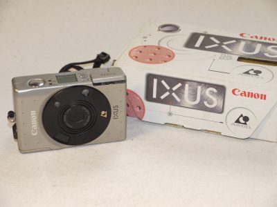 Canon IXUS IX240 APS Compact AF camera, Silver/Grey coloured with 24-48mm f4.5-6.2 Zoom lens + Strap & makers box. NEEDS APS FILM TO USE