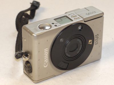 Canon IXUS IX240 APS Compact AF camera, Silver/Grey coloured with 24-48mm f4.5-6.2 Zoom lens + Strap & makers box. NEEDS APS FILM TO USE
