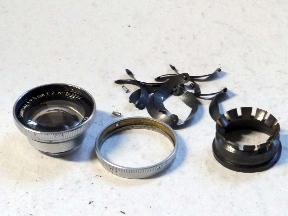 mwclassiccameras-20250221-87 Leitz Incomplete lens. 5cm f2 Summar front lens part (No.353234) with Aperture ring & loose set of Iris Blades