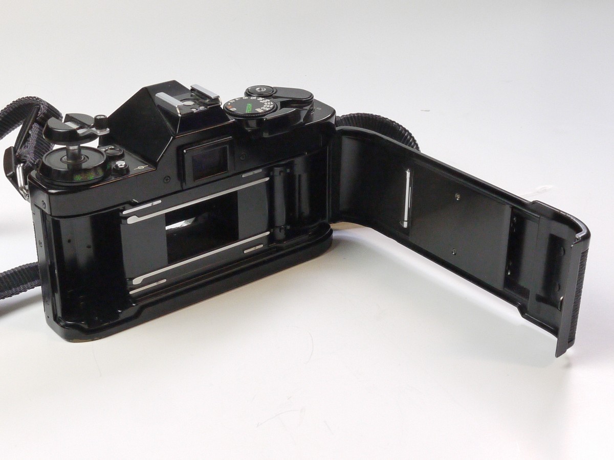 mwclassiccameras-20250418-88 Canon AE-1 Program 35mm SLR body, black + Canon Neck Strap. NEEDS REPAIR