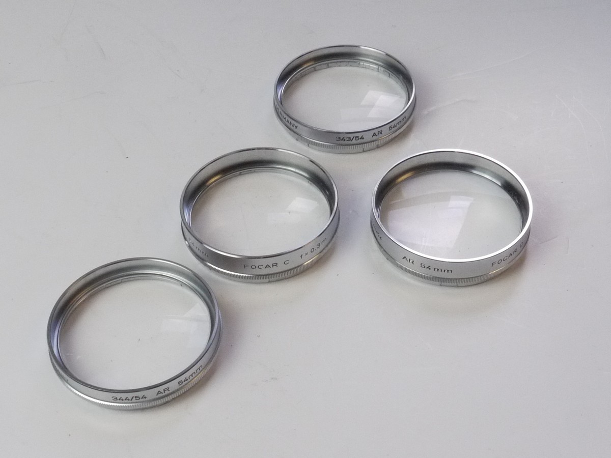 mwclassiccameras-20250425-91 Voigtlander Set of Four 54mm Push-On Close-Up lenses (Focar A, B, C & D) with one Keeper case. Fits the 50mm f2 Septon Bessamatic Deckel mount lens