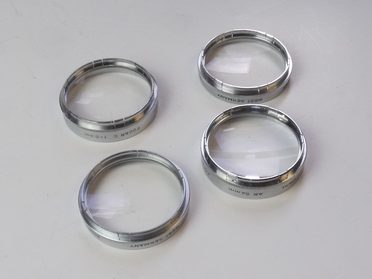 mwclassiccameras-20250425-92 Voigtlander Set of Four 54mm Push-On Close-Up lenses (Focar A, B, C & D) with one Keeper case. Fits the 50mm f2 Septon Bessamatic Deckel mount lens