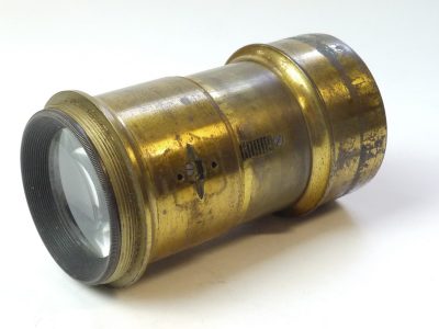 Unbranded 6 inch (Estimated) brass lens with collar & cog for rack & piunion fopcusing (control wheel is missing). With lens hood
