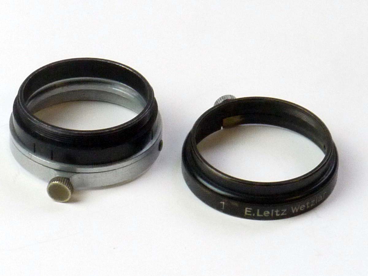 mwclassiccameras-20250530-157 Leitz Set of Two filter outer metal rings (One A36 black metal rings with fixing screw & Another A36 Chrome metal out ring withg added front part)