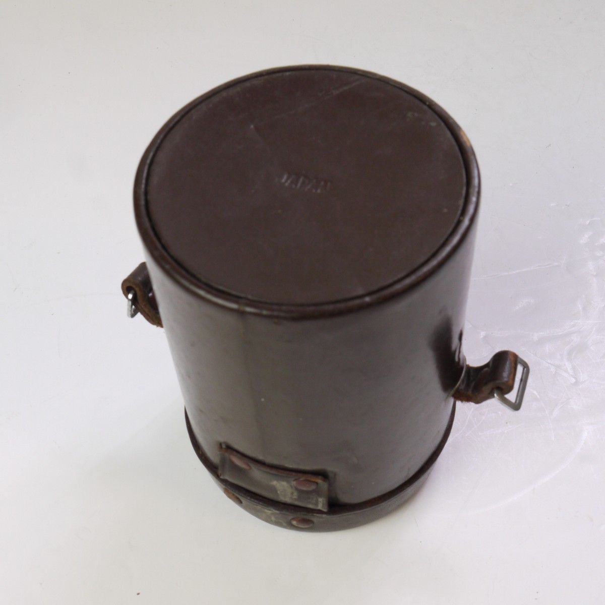 mwclassiccameras-20250620-206 Canon Hard leather bound brown lens case, marked on the top for the "Canon 85mm f1.9 R-A" (75mm x 110mm)
