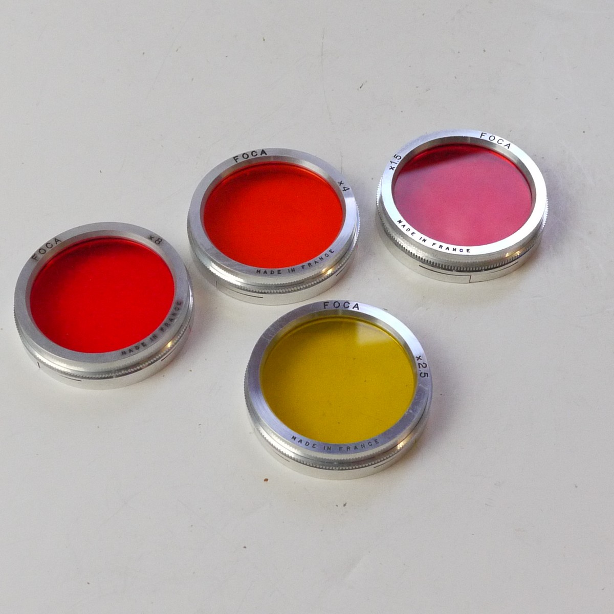 mwclassiccameras-20250627-165 Foca set of Four 42/43mm push-on filters for the Foca Leica Copy lenses (Yellow, Orange 4X, Red 8X & Dark Red) + 3 x keeper cases