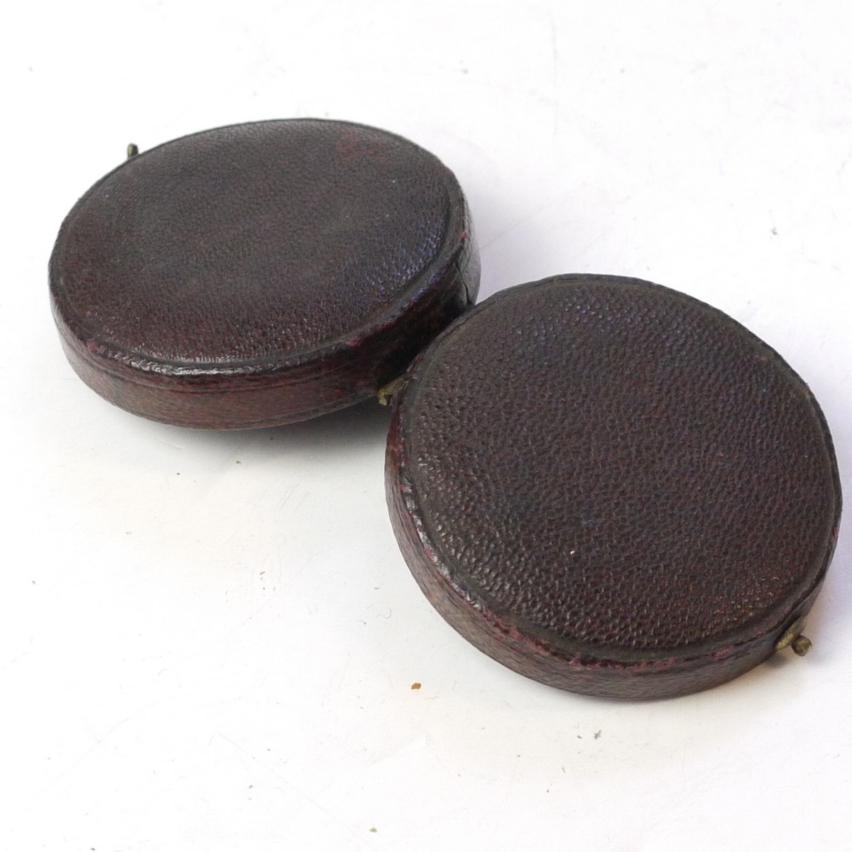 mwclassiccameras-20250627-182 Unamed small dark red leather bound filter case with dark blue inlay & hook lock, containing dark red & mediun red filter glasses