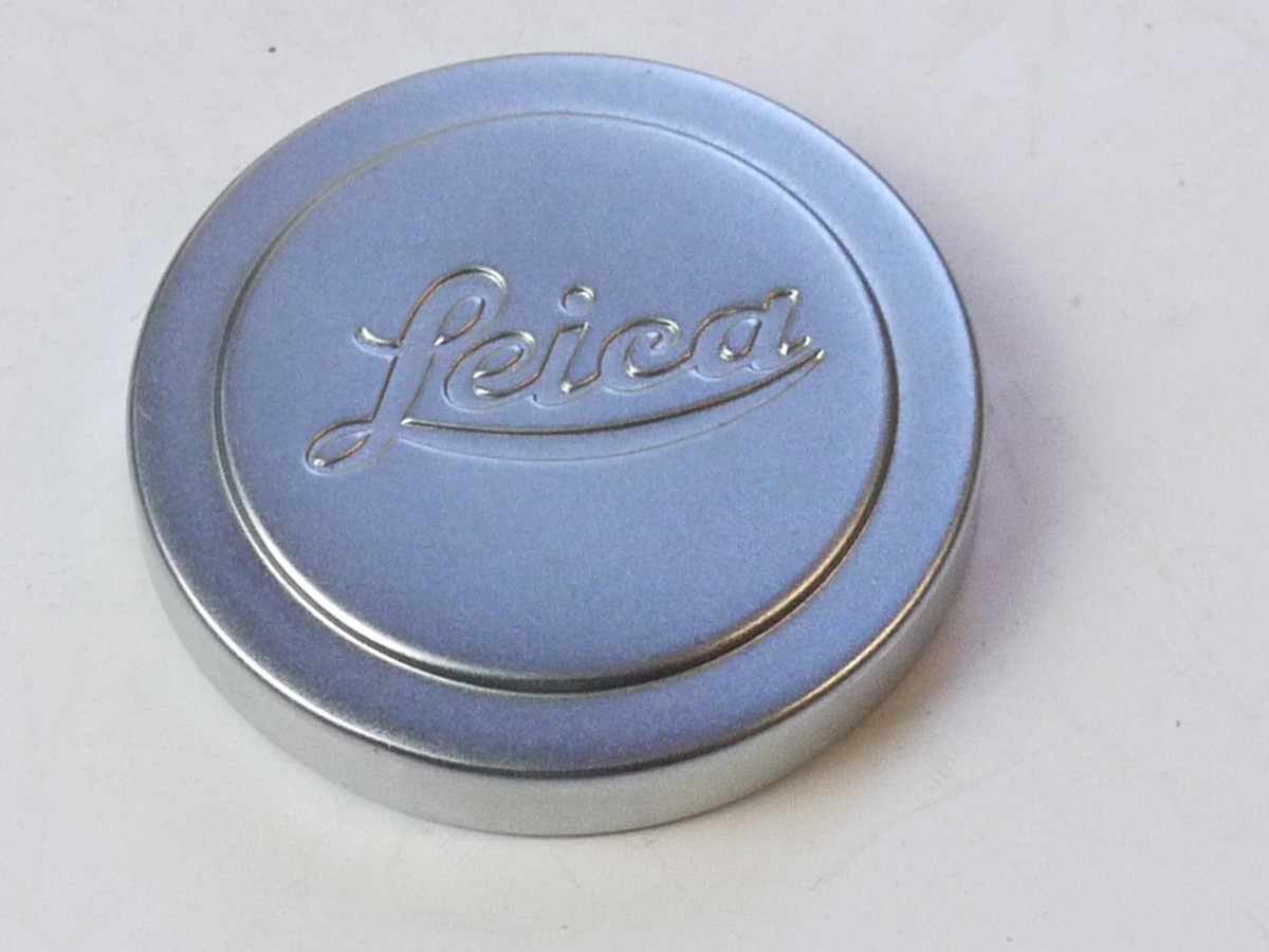 mwclassiccameras-20250711-220 Leitz "Leica" 42mm push-on chrome front lens cap, this type with slightly raised centre (for 5cm f2 Summitar). With red Felt edge inlay
