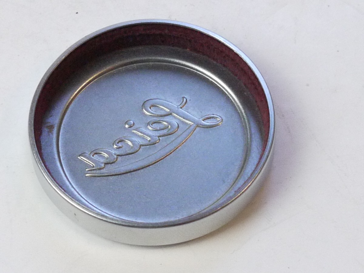 mwclassiccameras-20250711-221 Leitz "Leica" 42mm push-on chrome front lens cap, this type with slightly raised centre (for 5cm f2 Summitar). With red Felt edge inlay