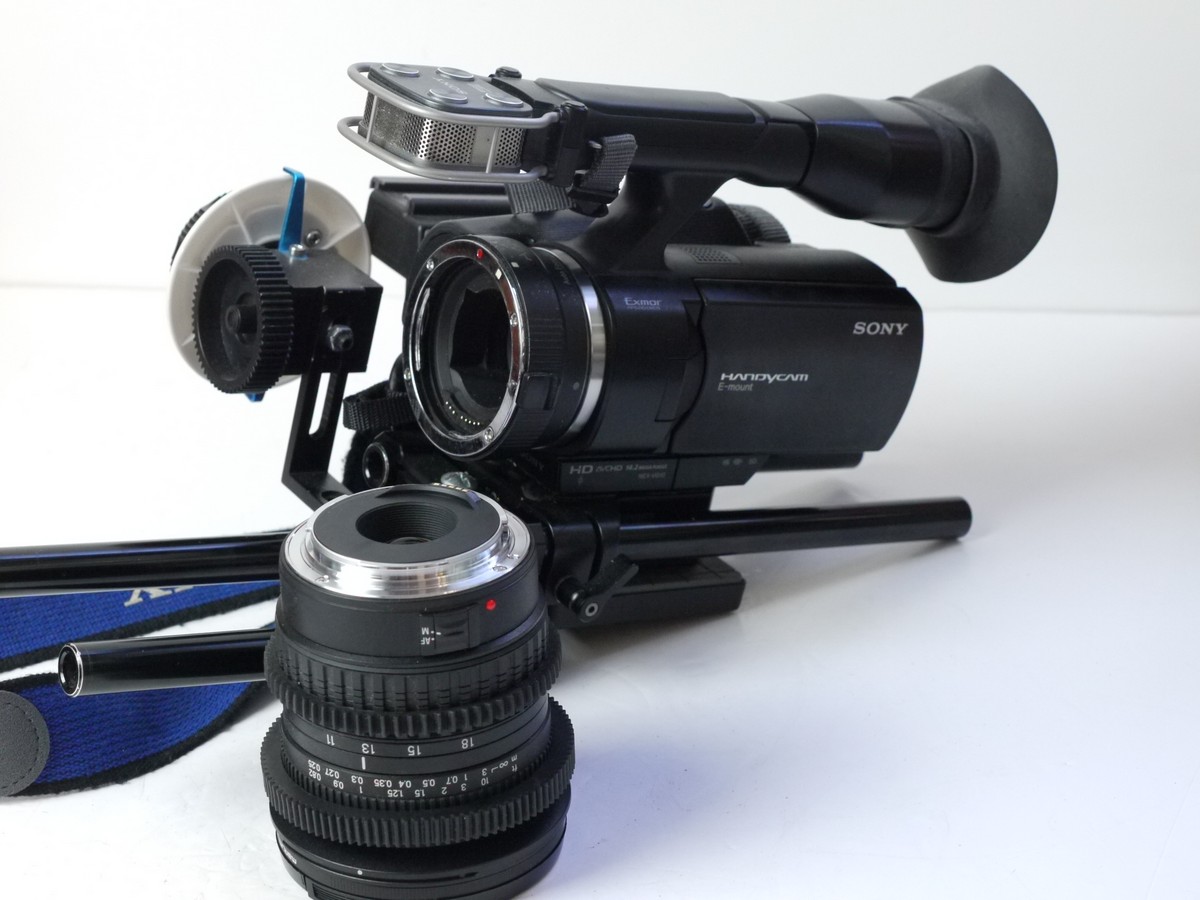 mwclassiccameras-20250718-168 Sony Handycam NEX-VG10E APS Camcorder, taking SD Cards + Sony Battery, Strap, Tamron SP 11-18mm f4.5 lens with an Andoer Sony E to Canon EFS mount adapter, with front cap + Neewer Rig with Focus module