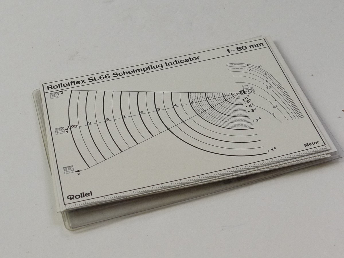 mwclassiccameras-20250725-146 Rollei Set of Four Rolleiflex SL66 Scheimpflug Indicator Cards for 50mm, 80mm, 150mm & 2500m. Double sided in Feet & Meters. In plastic Wallet case