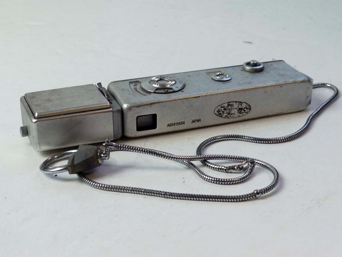 mwclassiccameras-20250801-180 Yashica Atoron Subminiature Camera, chrome, with side mounting Yashica Atoron Flash Gun & Chain Strap with notches for aiding distance measurement