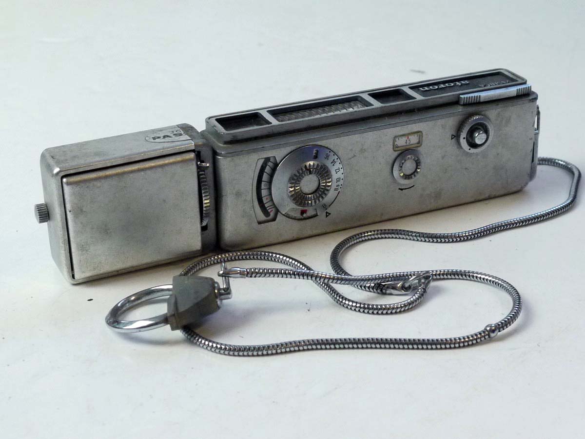 mwclassiccameras-20250801-181 Yashica Atoron Subminiature Camera, chrome, with side mounting Yashica Atoron Flash Gun & Chain Strap with notches for aiding distance measurement