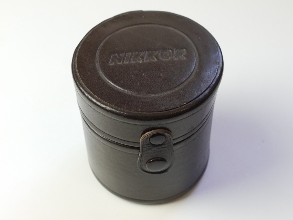 mwclassiccameras-20250822-16 Nikon brown leather lens case, marked "Nikkor", with purple inlay. 100mm x 95mm