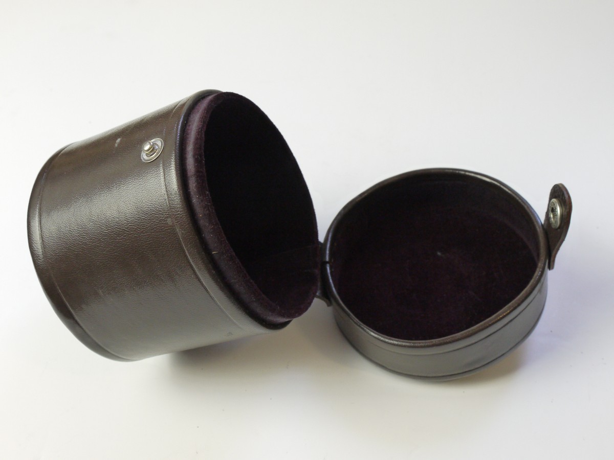 mwclassiccameras-20250822-17 Nikon brown leather lens case, marked "Nikkor", with purple inlay. 100mm x 95mm