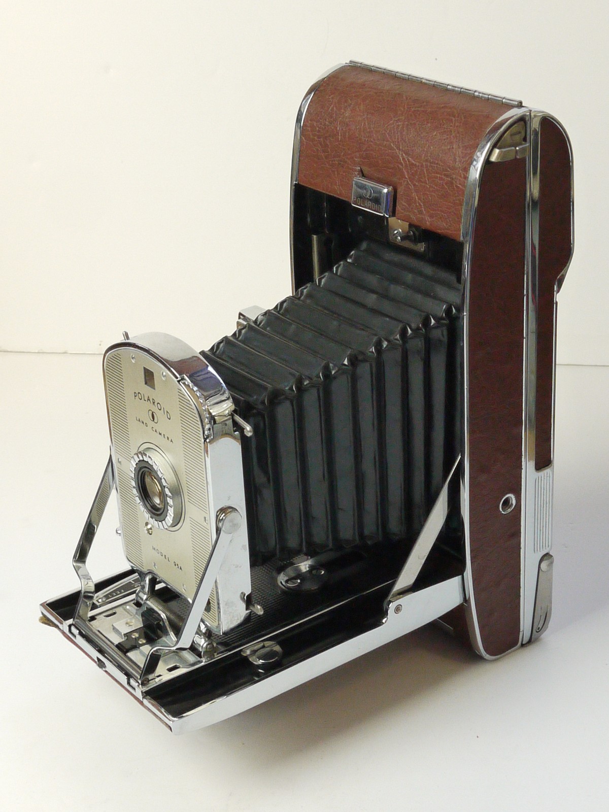 mwclassiccameras-20250822-179 Polaroid Land Camera Model 95A. Albada & Sports Finder, Brown Covering. Black Bellows. Single speed Shutter