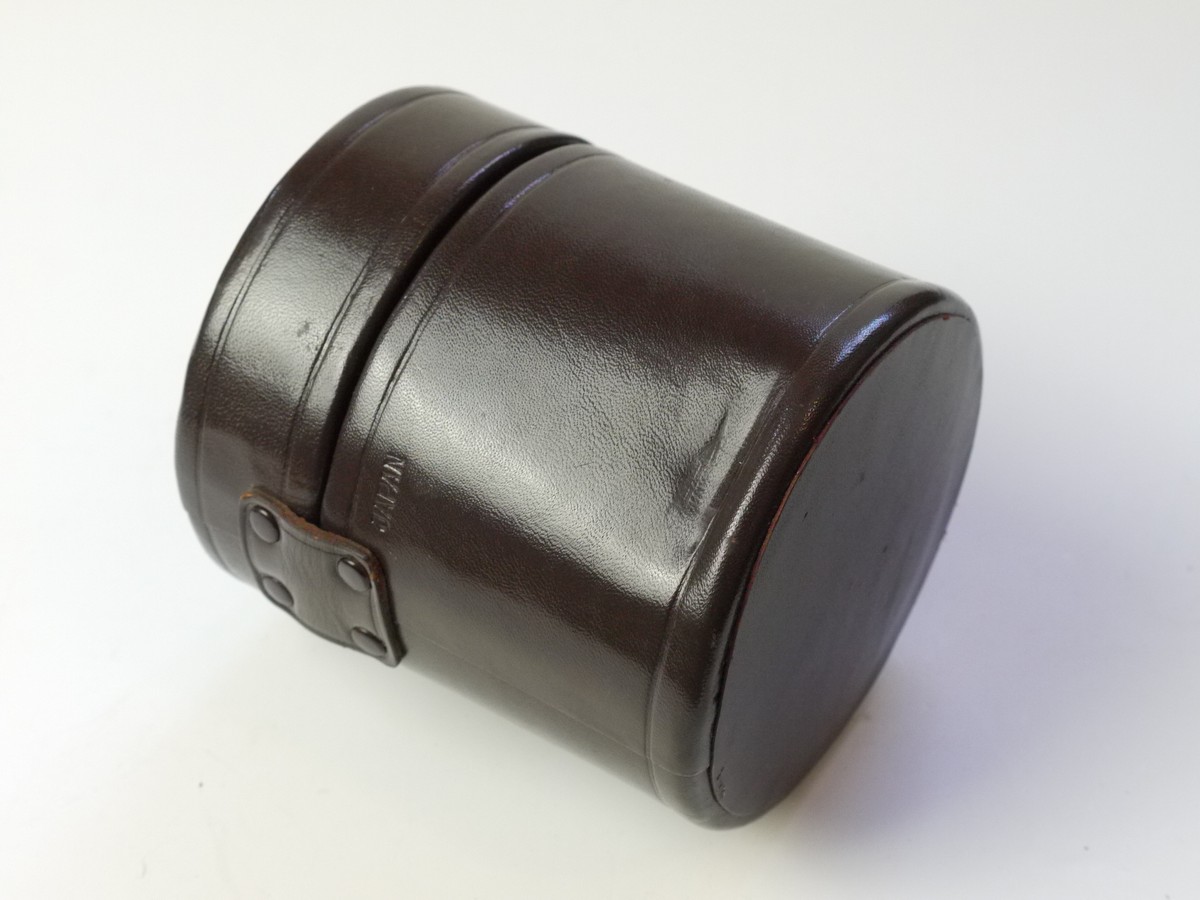 mwclassiccameras-20250822-18 Nikon brown leather lens case, marked "Nikkor", with purple inlay. 100mm x 95mm