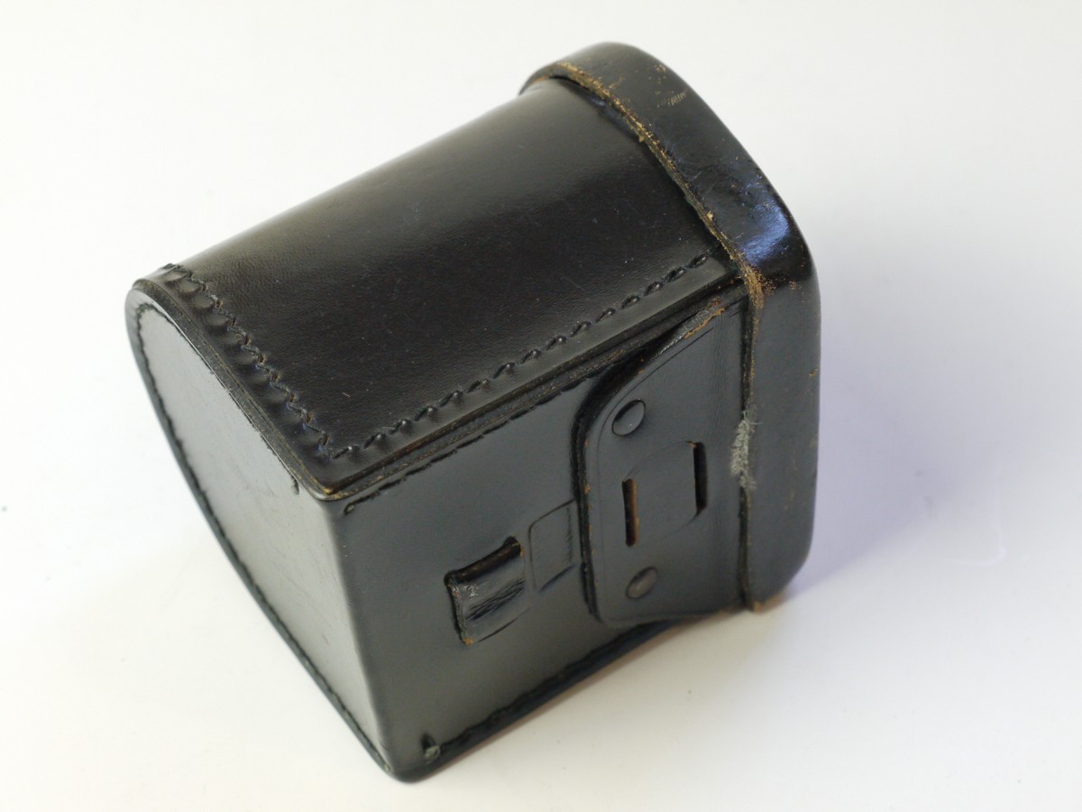mwclassiccameras-20250822-69 Zeiss Ikon Black leather lens/Accessory case (23.1004), semi circular shaped, with filter holder on inside lid. 80mm x 75mm x 70mm