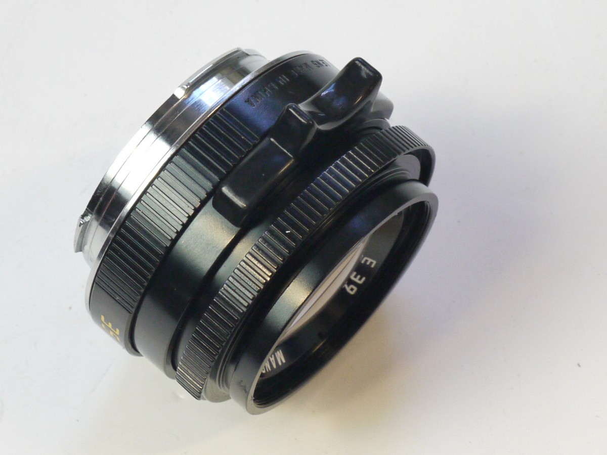 mwclassiccameras-20250829-205 Mandler 35mm f2 "Summi-Cron-M" 7-Element Black lens, Limited Production (430 out of 999) based on the Leica 35mm f2 Summicron-M lens. A Well-Regarded, Quality-made lens with very nice bokeh, Made in China in Leica M mount + Unbranded Clip-on Metal lens hood with vents (Copy of Leitz Hooid), Mandler E39 UVa filter, black rim, Unbranded Clip-on plastic lens hood (marked 12526) Mandler front cap, Rear lens cap, Hood/filter Box, keeper case & main Box with packaging & outer box.