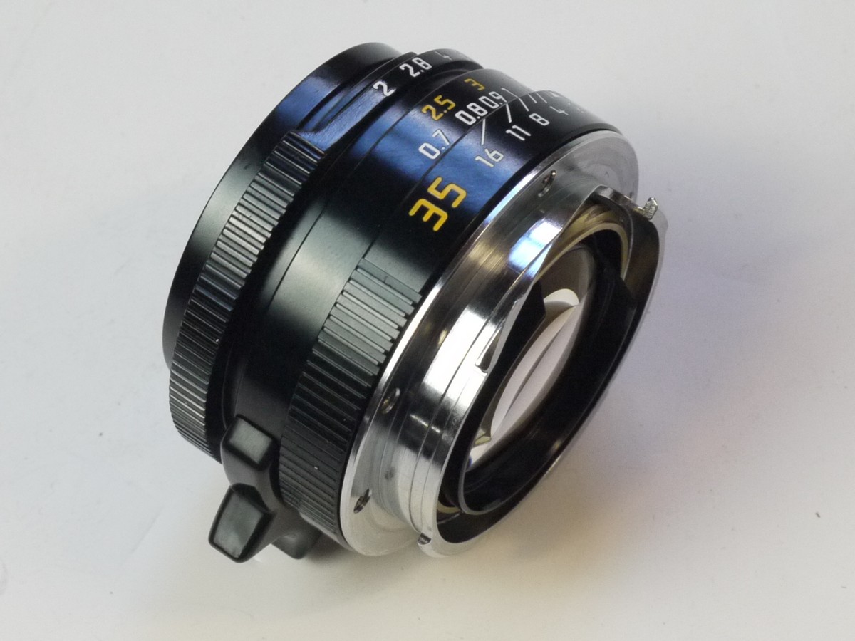 mwclassiccameras-20250829-206 Mandler 35mm f2 "Summi-Cron-M" 7-Element Black lens, Limited Production (430 out of 999) based on the Leica 35mm f2 Summicron-M lens. A Well-Regarded, Quality-made lens with very nice bokeh, Made in China in Leica M mount + Unbranded Clip-on Metal lens hood with vents (Copy of Leitz Hooid), Mandler E39 UVa filter, black rim, Unbranded Clip-on plastic lens hood (marked 12526) Mandler front cap, Rear lens cap, Hood/filter Box, keeper case & main Box with packaging & outer box.