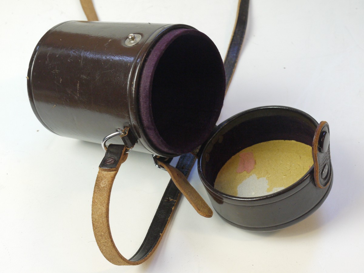 mwclassiccameras-20250829-212 Nikon brown leather lens case, marked "Nikkor" on top, with strap & with red felt inlay. 138 x 83mm
