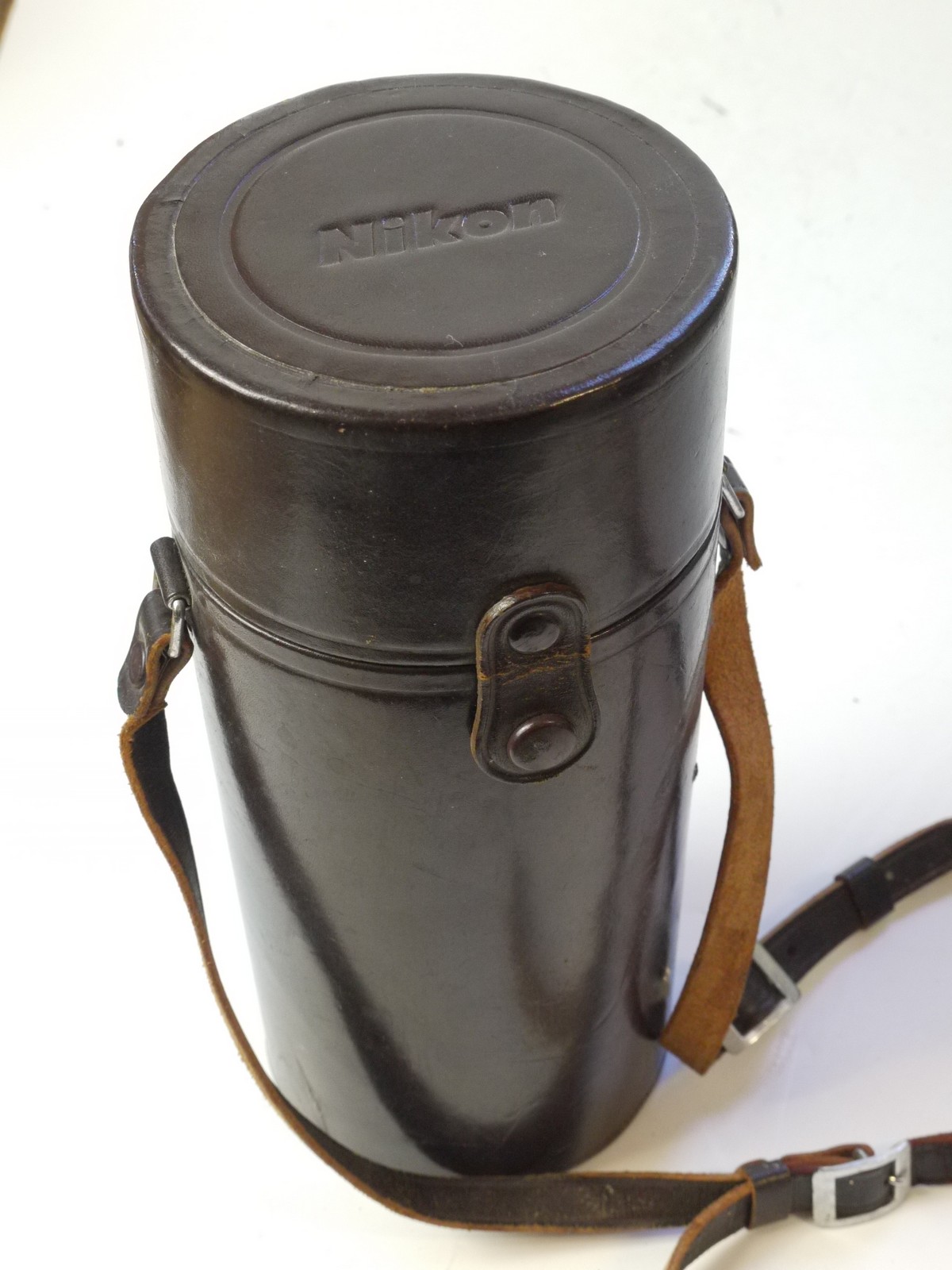 mwclassiccameras-20250829-213 Nikon brown leather lens case with strap & with purple felt inlay. 240 x 103mm