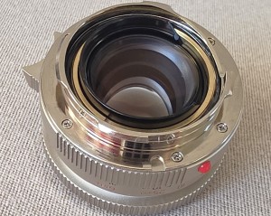 mwc20251226-147 Mandler 35mm f2 7-Element NICKEL Leica M Mount lens (No. 052/100) Limited Edition of 100 only. With Front Cap, Keeper Case, Square Black lens Hood (12526), Round Chrome Lens Hood with Vents (12504), UVa Filter, All Boxed & with SEALED Lens Outer Box