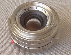 mwc20251226-149 Mandler 35mm f2 7-Element NICKEL Leica M Mount lens (No. 052/100) Limited Edition of 100 only. With Front Cap, Keeper Case, Square Black lens Hood (12526), Round Chrome Lens Hood with Vents (12504), UVa Filter, All Boxed & with SEALED Lens Outer Box