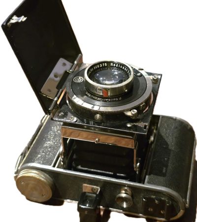 Korelle 6x4.5 on 120 4-strut folding camera with front hinging door, with 7.5cm f2.9 Radionar lens in Compur shutter.UNCOMMON