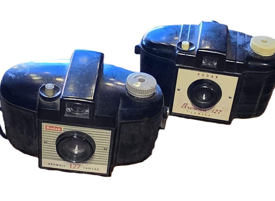 20260501-182 Set of Two Kodak Brownie 127 Cameras, Black Bakelite bodies with straps. One with Patterned front, one with Plain front