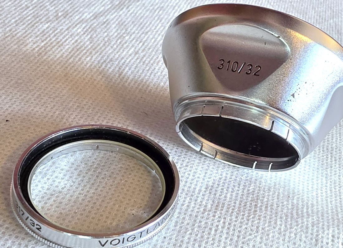 20260529-23 Voigtlander 32mm push-on chrome lens hood (310/32) + Voigtlander UV Filter (317/32)
