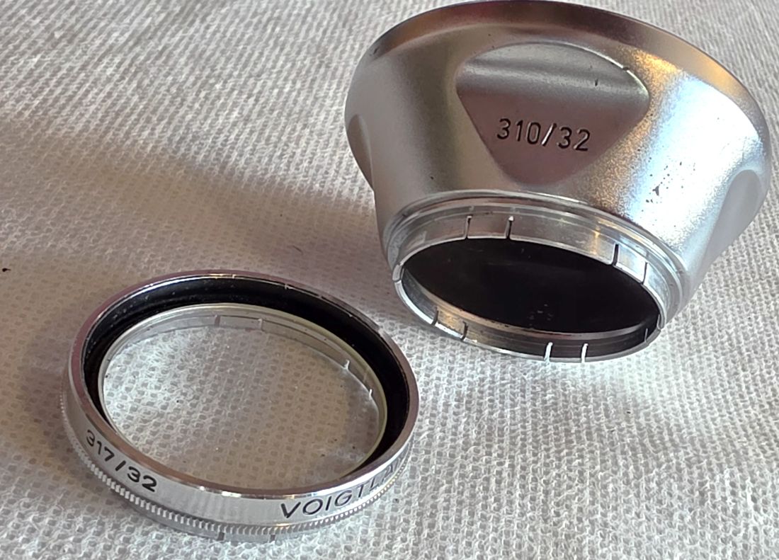 20260529-24 Voigtlander 32mm push-on chrome lens hood (310/32) + Voigtlander UV Filter (317/32)